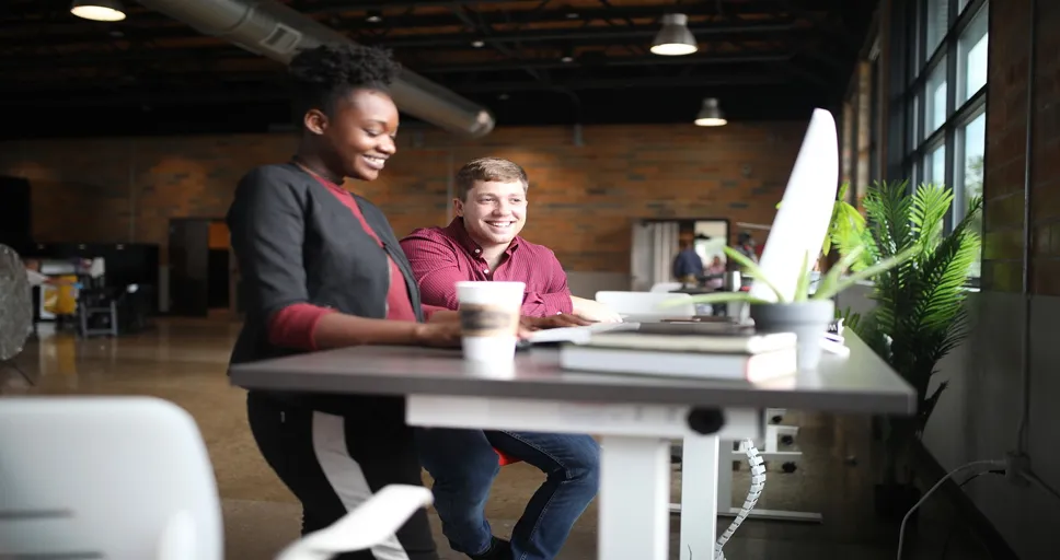 signs a coworker likes you but is hiding it - office desk, workspace, coworkers