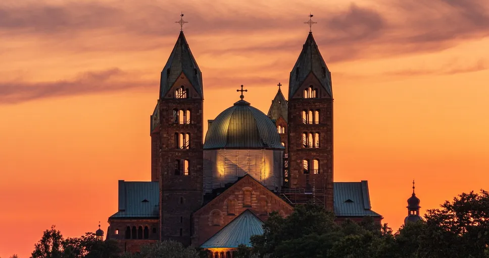 signs he likes you but is hiding it at work - cathedral, church, sunset